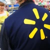 Walmart employee helping Walmart customer in store