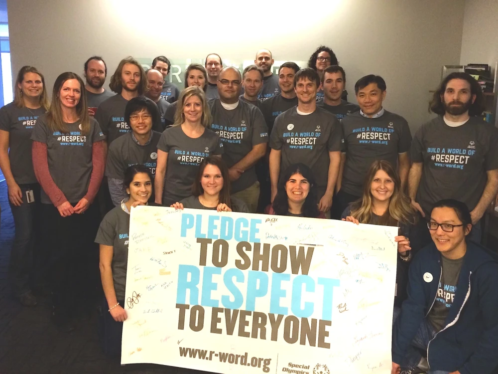 group of Brightspot employees with signed Pledge to Show Respect to Everyone signboard