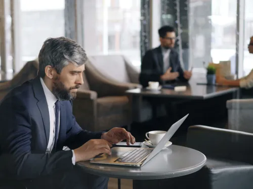 image of male businessman in suit working on laptop