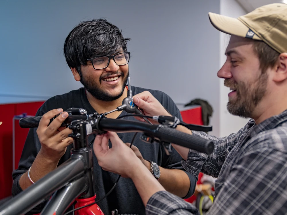 image of Brightspot employees assembling a bicycle as part of a bike donation event for charity