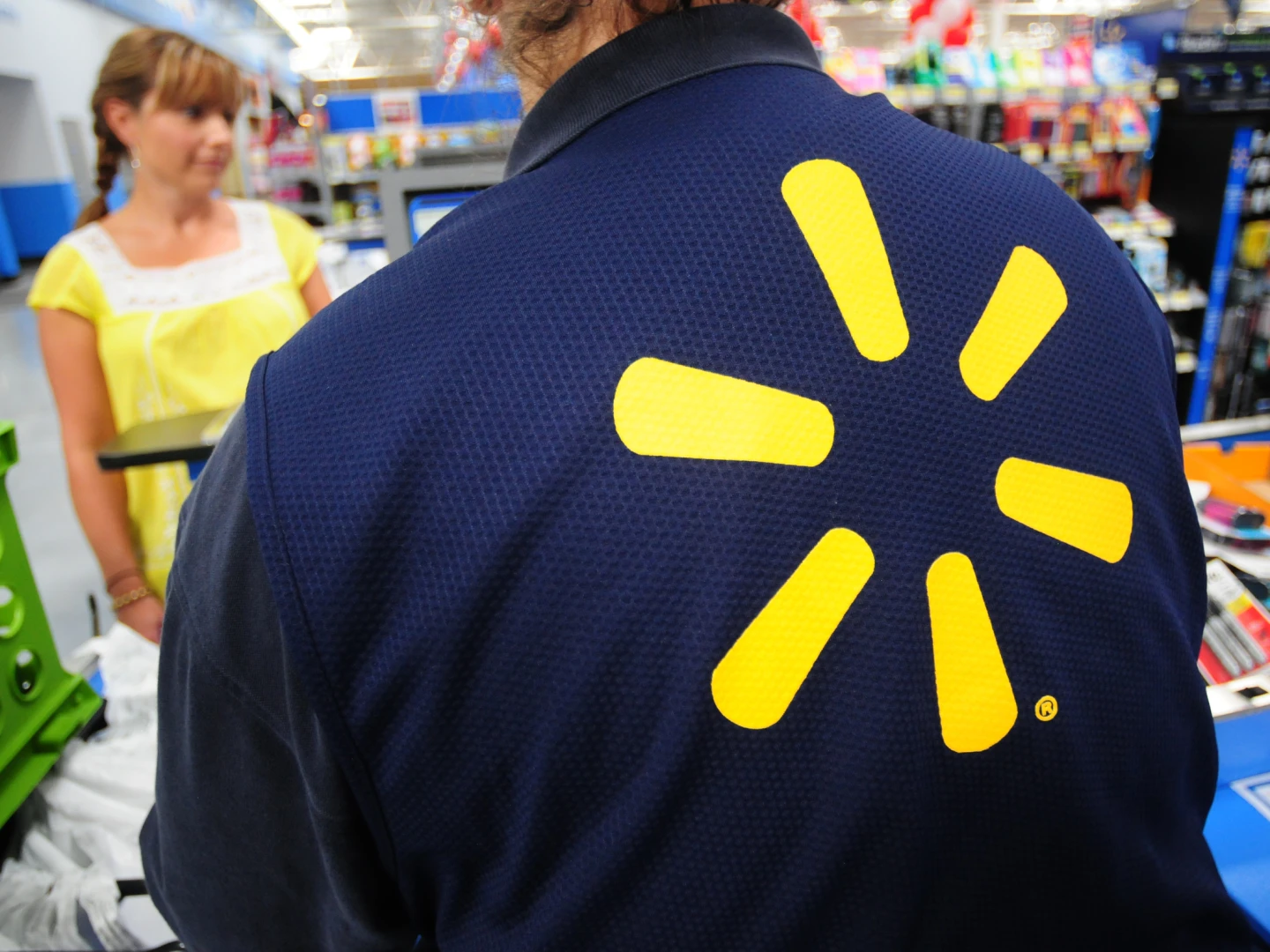 Walmart employee helping Walmart customer in store