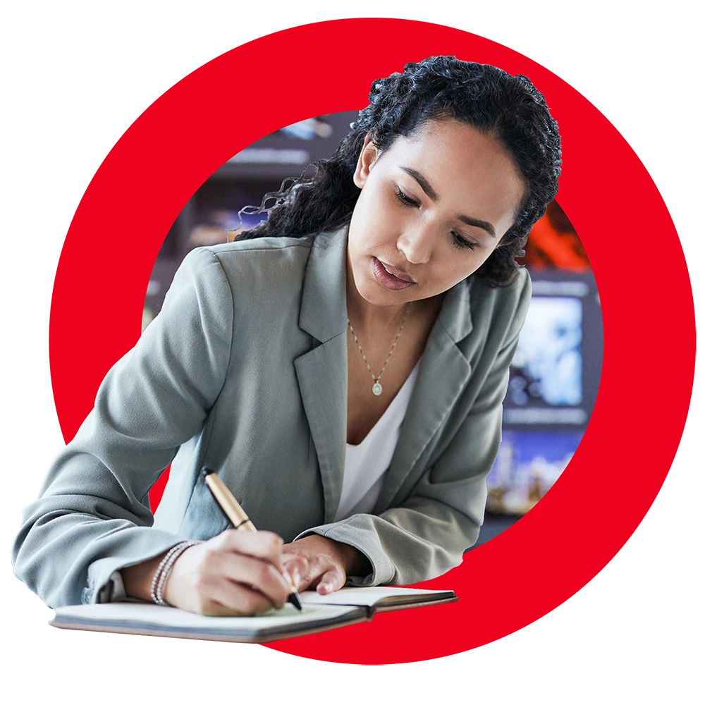 graphic showing female content creator writing in notebook framed by circular red Brightspot logo and background image of an office setting
