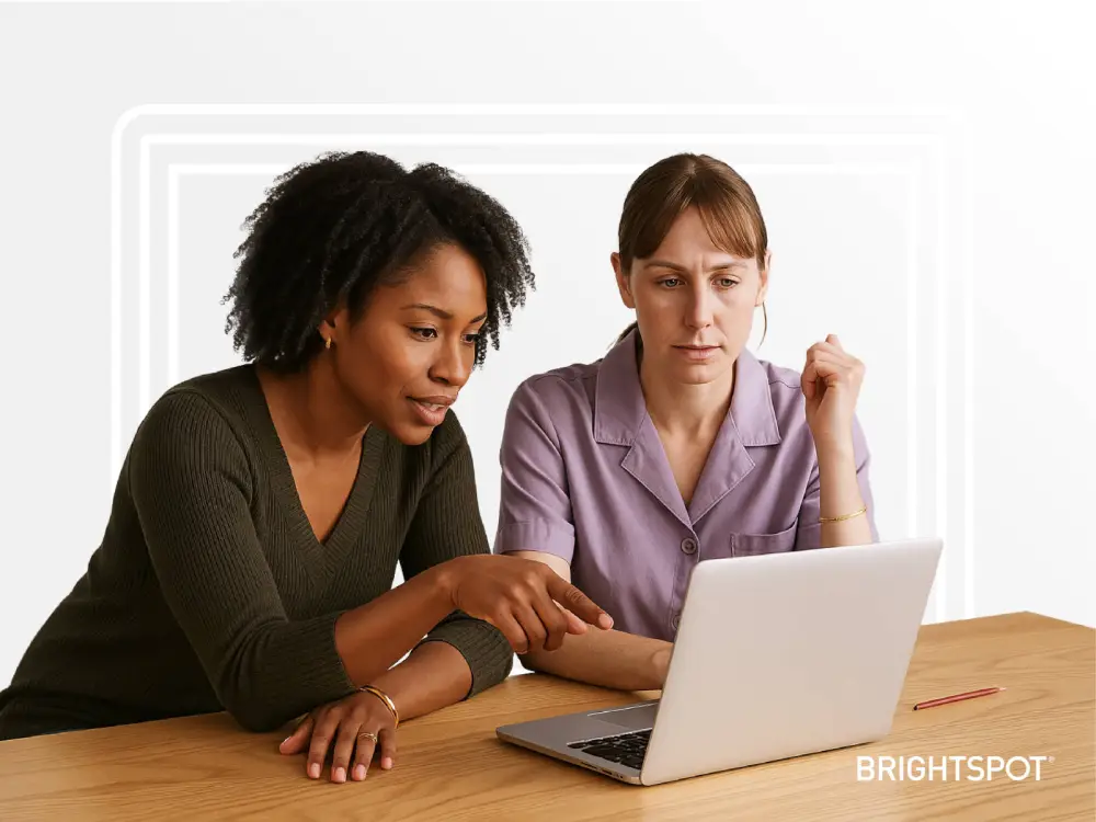 Brighstpot CMS placeholder graphic: two female professional looking at a laptop screen together