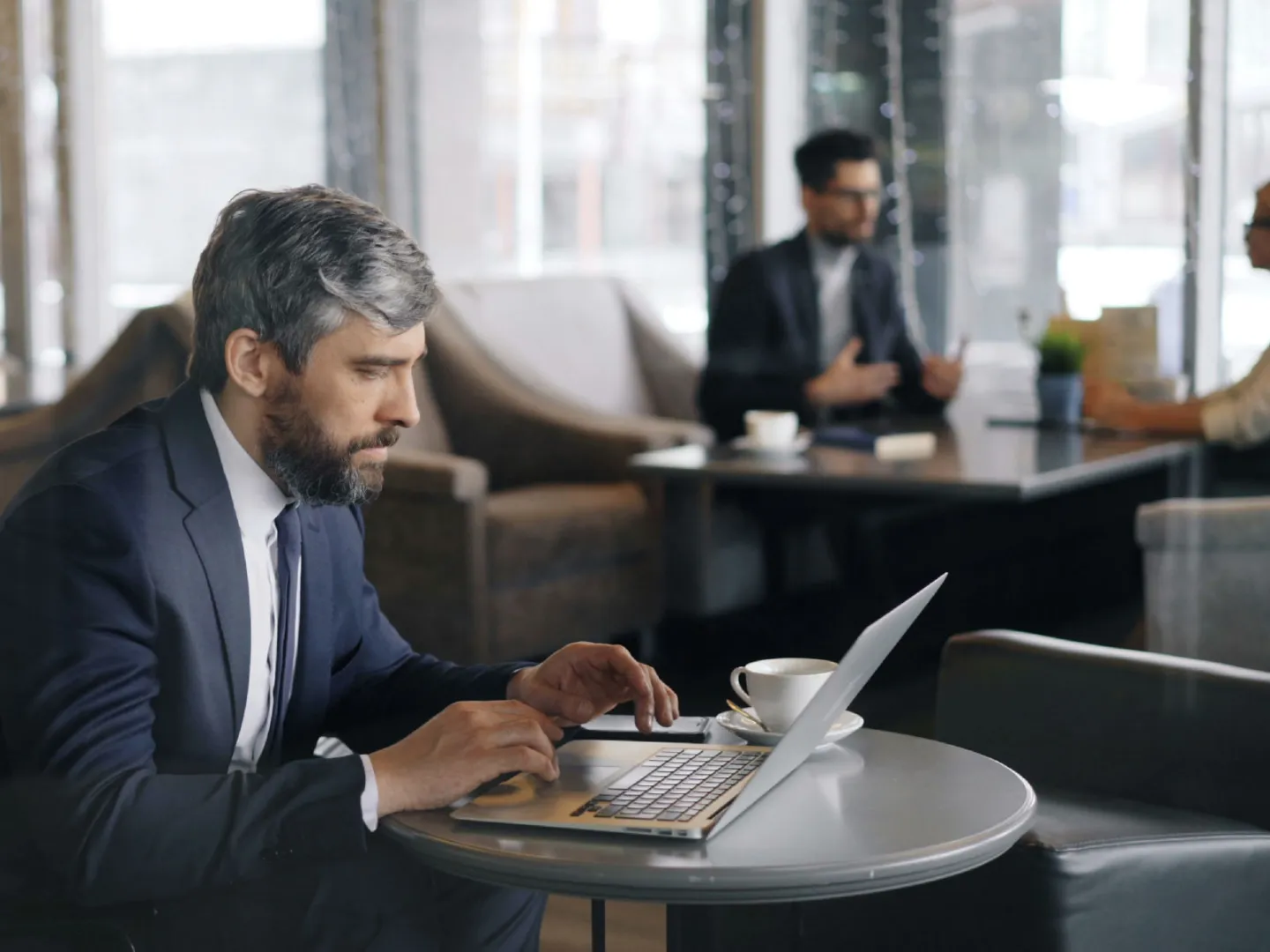 image of male businessman in suit working on laptop
