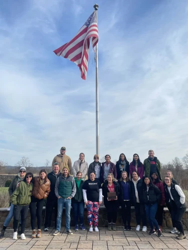 group of Brightspot volunteers in front of flagpole the Boulder Crest Foundation's Bluemont, VA, campus